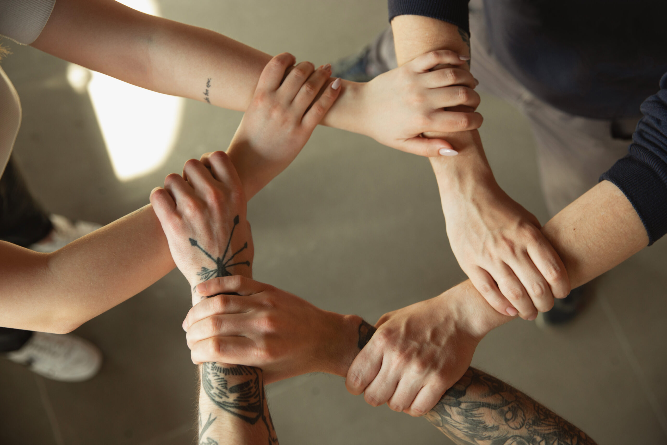Close up of caucasian male and female hands, covering one another, shaking. Concept of business, finance, job. Copyspace for ad. Education, communication and freelance. Teambuilding, support.
